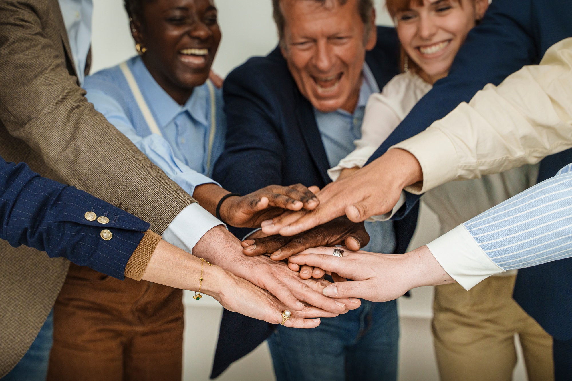 Multicultural Team Celebrating Unity with Hands Joined in Success